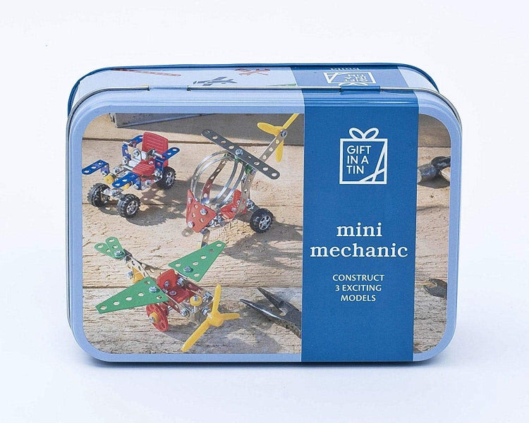 Packaged toy set with 'mini mechanic' label on a wooden surface