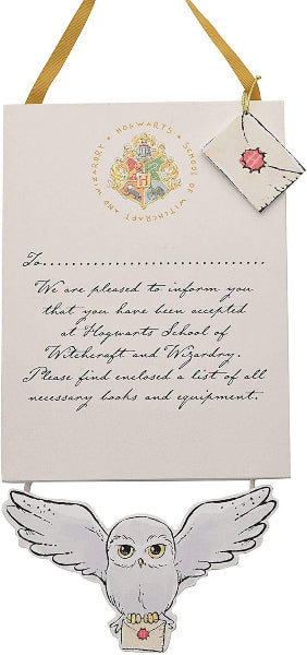 Hogwarts acceptance letter with owl and envelope on a white background