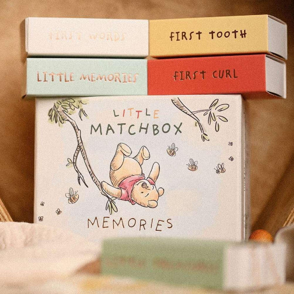 Set of memory boxes with illustrations and text on a wooden surface
