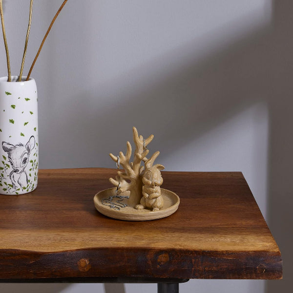 Decorative items on a wooden table with a plain background