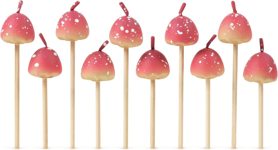 Pink and white cake pops on sticks arranged in a row against a white background
