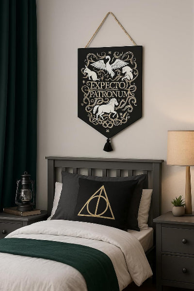Decorative wall hanging with 'EXPECTO PATRONUM' text above a bed in a bedroom setting.