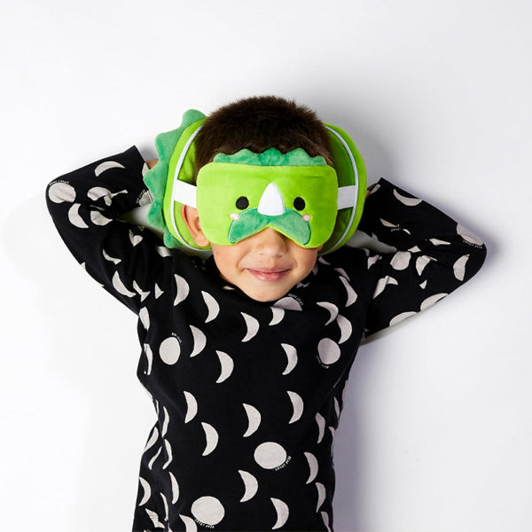 Child wearing a dinosaur-themed eye mask and headband on a white background
