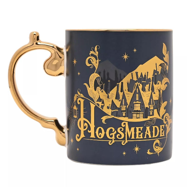 A dark navy blue ceramic mug with a gold handle and gold printed Hogwarts castle design, featuring the text 'HOGSMEADE' on a white background.