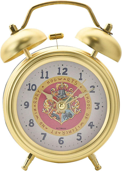 Gold alarm clock with Hogwarts crest on a white background