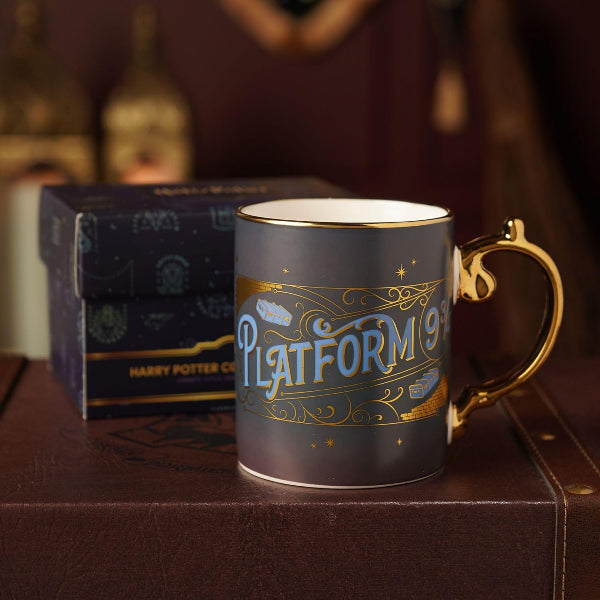 Harry Potter-themed mug with 'Platform 9 3/4' text on a wooden surface with a box in the background.