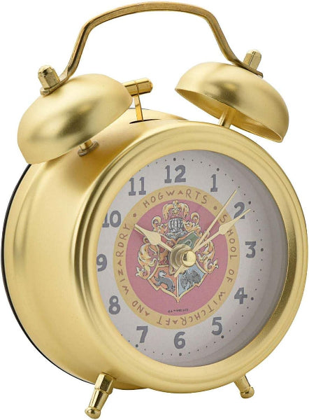 Gold alarm clock with a Harry Potter-themed face on a white background