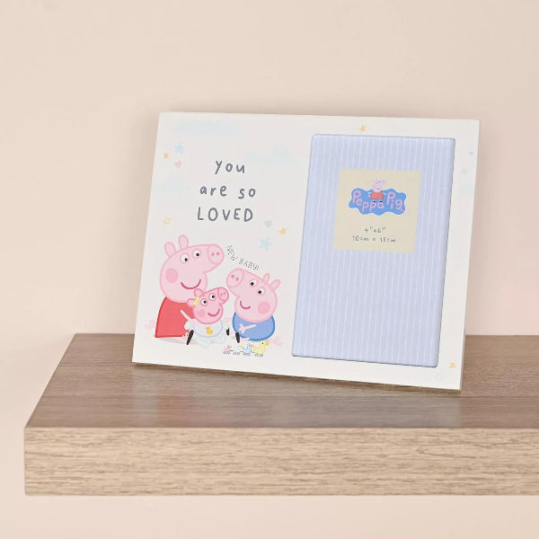 Frame with Peppa Pig design on a wooden surface