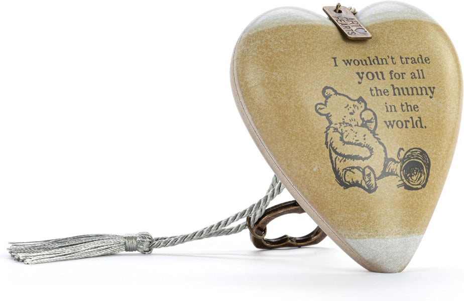 Heart-shaped wooden keepsake box with a tassel and metal clasp, featuring Winnie the Pooh illustration and the quote 'I wouldn't trade you for all the honey in the world.' on a white background.