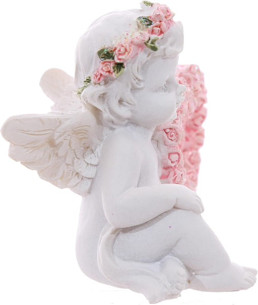 White angel figurine with floral wings and headband on a white background