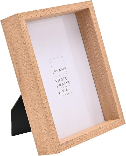 A light oak wood picture frame with a recessed design and a black triangular stand, shown on a white background with a white insert card.