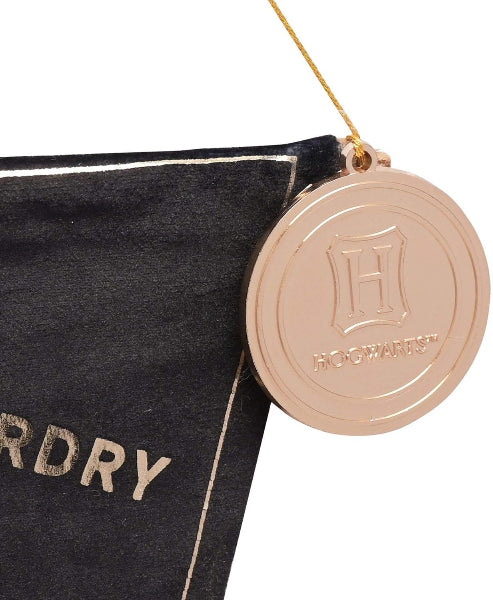 Black bag with a gold 'Hogwarts' medallion on a white background