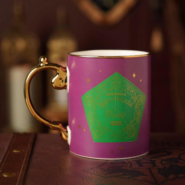 Purple mug with gold handle featuring green geometric design on a dark background