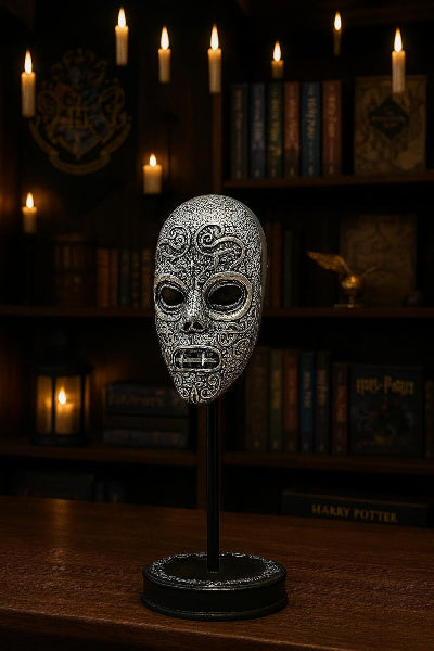 Decorative mask on a stand with candles and books in the background