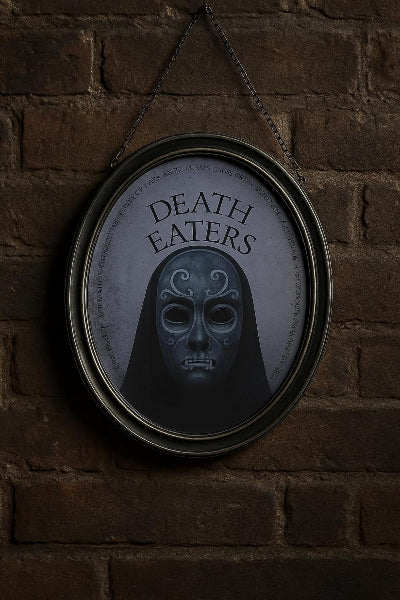 Framed picture of a mask with 'Death Eaters' text on a brick wall