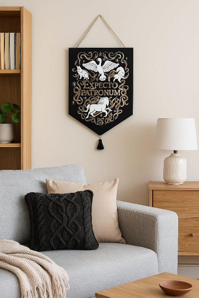 Decorative banner with 'EXPECTO PATRONUM' text and lion design hanging above a living room sofa.