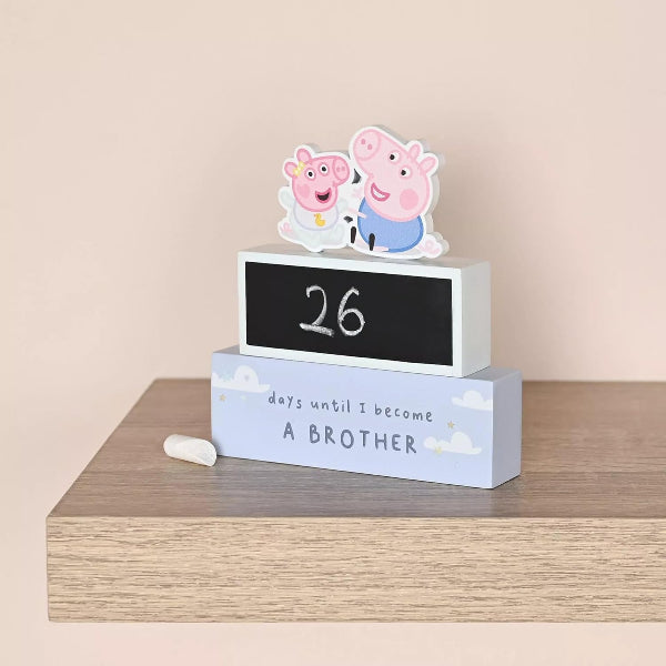 Countdown calendar with Peppa Pig-themed figures on a wooden surface