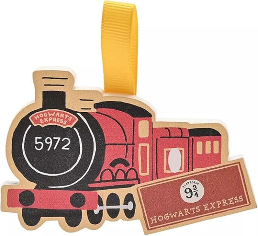 Hogwarts Express train-shaped ornament with a yellow ribbon on a white background
