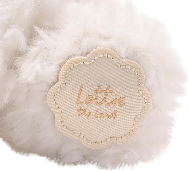 Close-up of a fluffy white toy with a 'Lottie the Lamb' label.