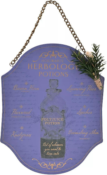 A decorative hanging sign shaped like a purple potion bottle label, with a gold chain at the top, gold text reading 'Herbology Potions,' a central potion bottle illustration, and a small green sprig tied to the right side.
