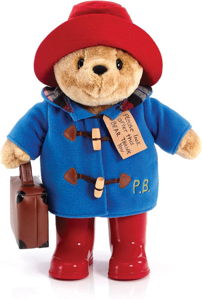 Paddington Bear toy with red hat, blue coat, and red boots holding a suitcase.