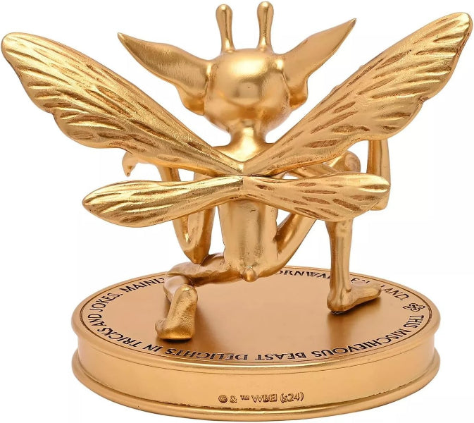 Gold bee-shaped figurine on a white background