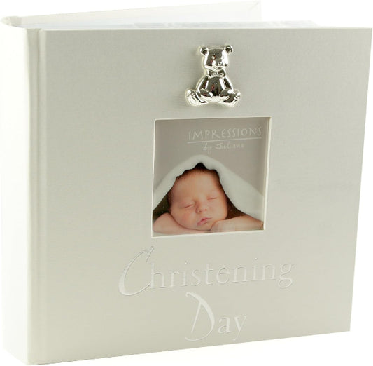 White photo album with a teddy bear clip and 'Christening Day' text, featuring a baby photo inside.