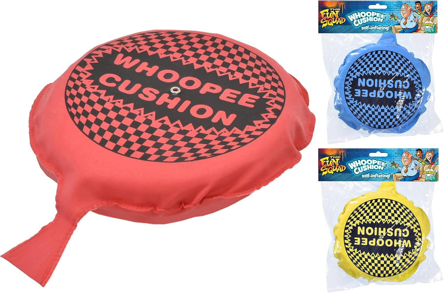 Red whoopee cushion with checkered pattern and text, along with two smaller cushions in blue and yellow.