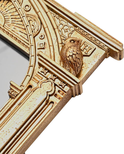 Decorative gold frame with intricate designs and an owl emblem on a white background