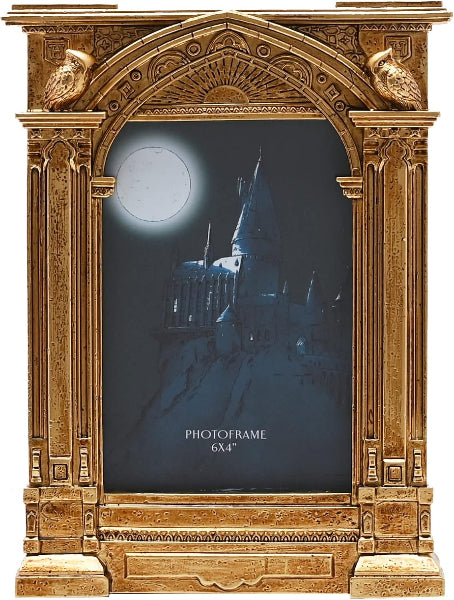Decorative gold photo frame with a castle silhouette on a dark background