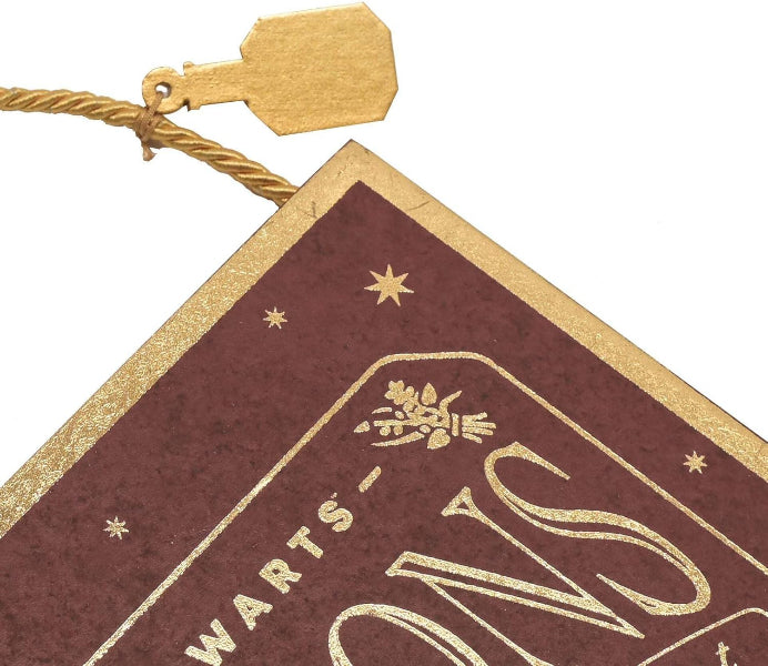 Decorative sign with gold text and design on a white background