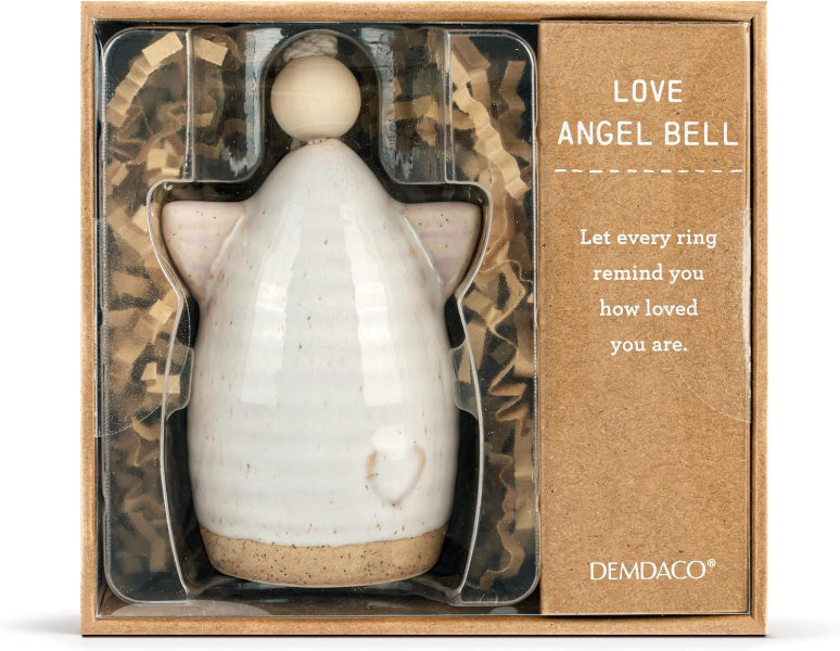 A ceramic angel bell gift set by DEMDACO, featuring a speckled off-white angel figurine with a wooden bell and a heart detail, presented inside a brown kraft gift box with crinkle paper and a card that reads 'LOVE ANGEL BELL'..