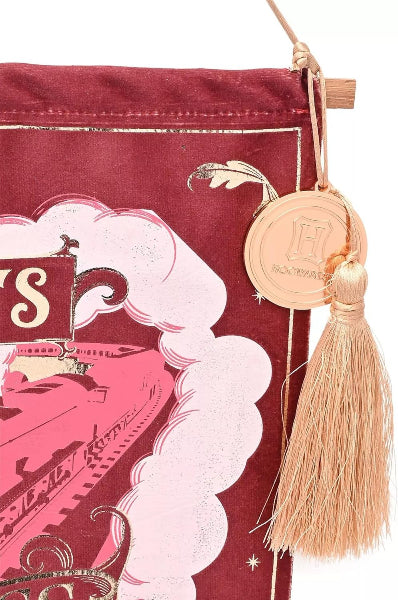 Decorative banner with tassel and coin on a red background