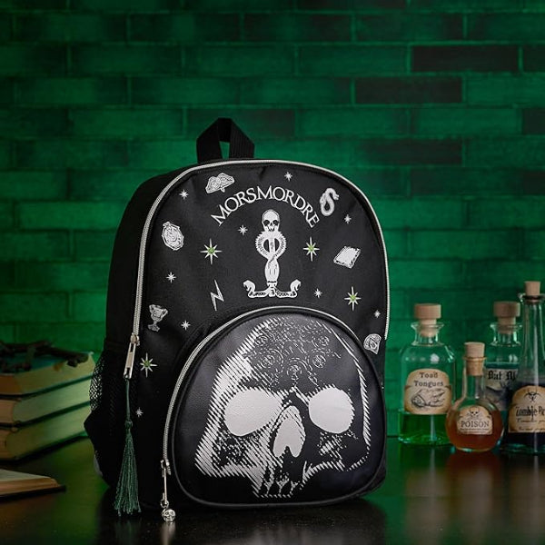 Black backpack with skull design and 'Morsmordre' text on a green brick wall background.