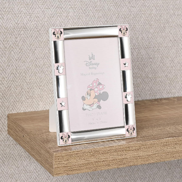 Silver photo frame with pink accents featuring a Disney character on a wooden surface.