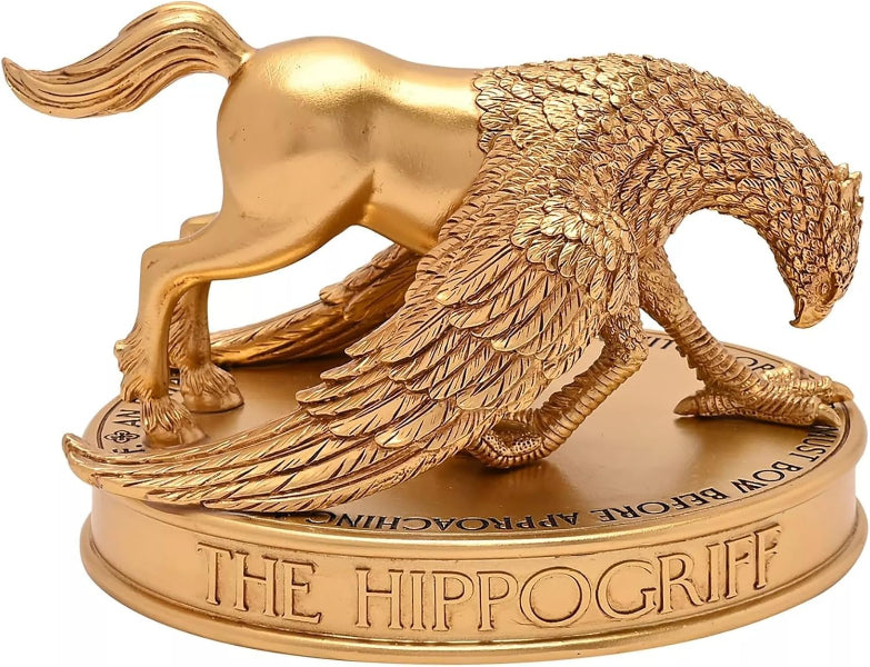 Gold hippogriff figurine on a white background