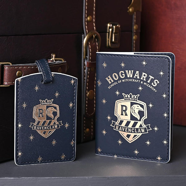 Hogwarts Ravenclaw themed luggage tag and passport holder on a dark surface with a suitcase in the background.