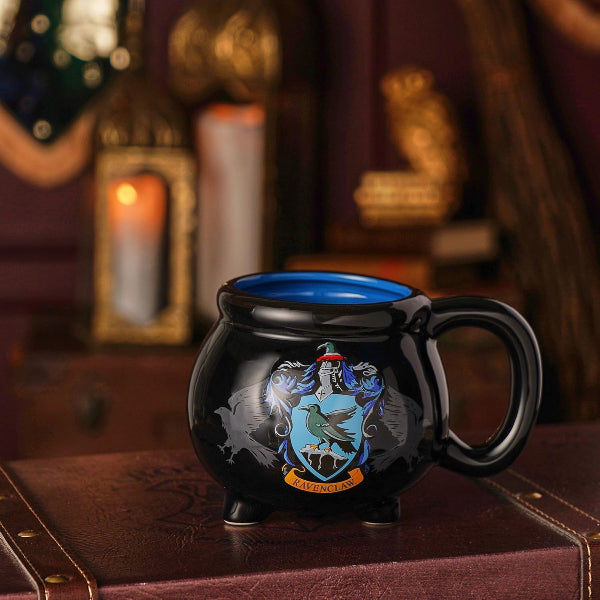Black mug with a Ravenclaw crest on a wooden surface with a warm background