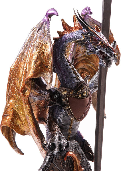 Close-up of a detailed dragon figurine with gold and purple accents on a white background