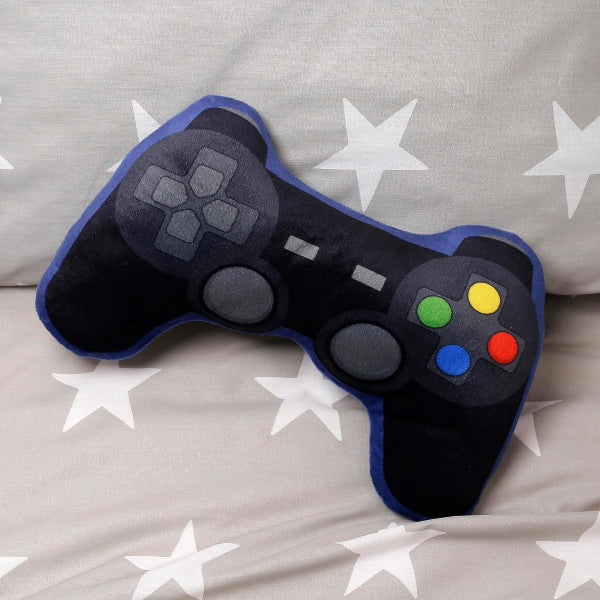 Plush toy shaped like a video game controller on a bed with star patterns