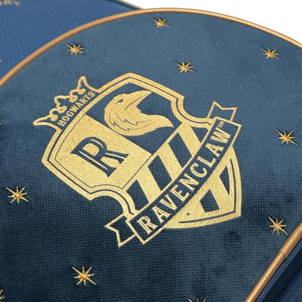 Close-up of a Ravenclaw emblem on a blue background with stars.