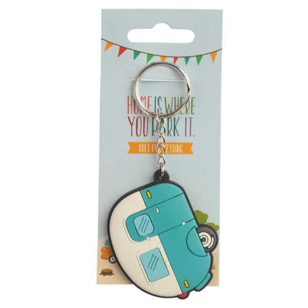 Keychain shaped like a camper van on a packaging card with text.