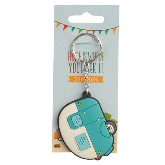 Keychain shaped like a camper van on a packaging card with text.
