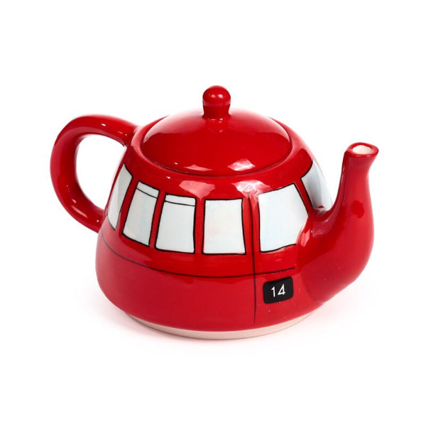 Red teapot with white window designs on a white background