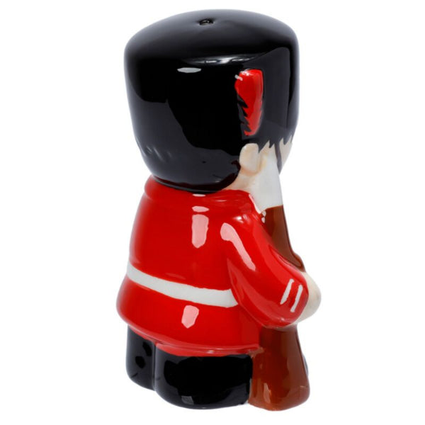 Ceramic figure of a character in a red outfit with a black helmet on a white background