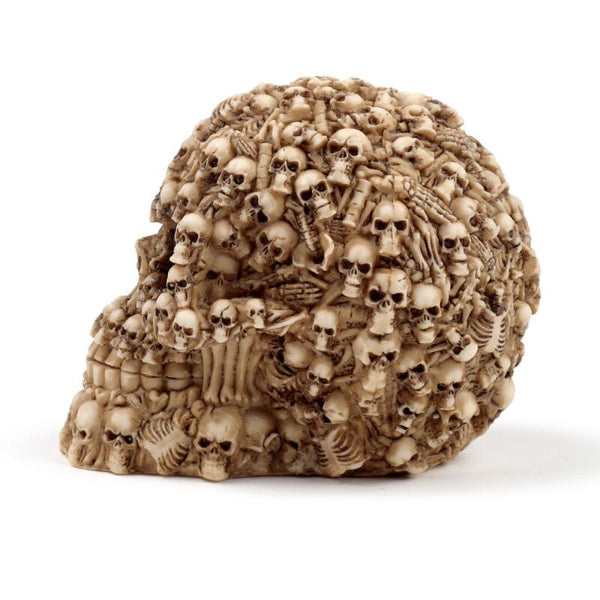 Decorative piece with intricate carvings of skulls and bones on a white background