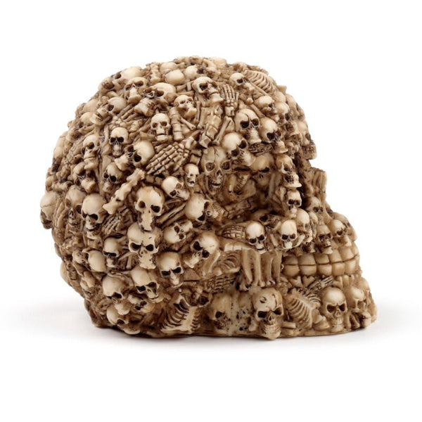 Decorative skull sculpture with intricate carvings on a white background