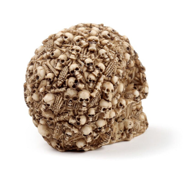 Decorative skull sculpture with intricate carvings on a white background