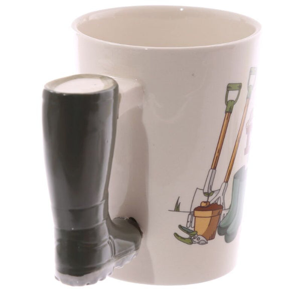 Mug with a boot-shaped handle and gardening-themed design on a white background