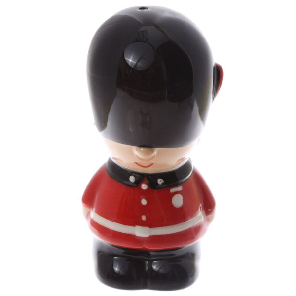 Figurine of a British guard in red uniform and black helmet on a white background